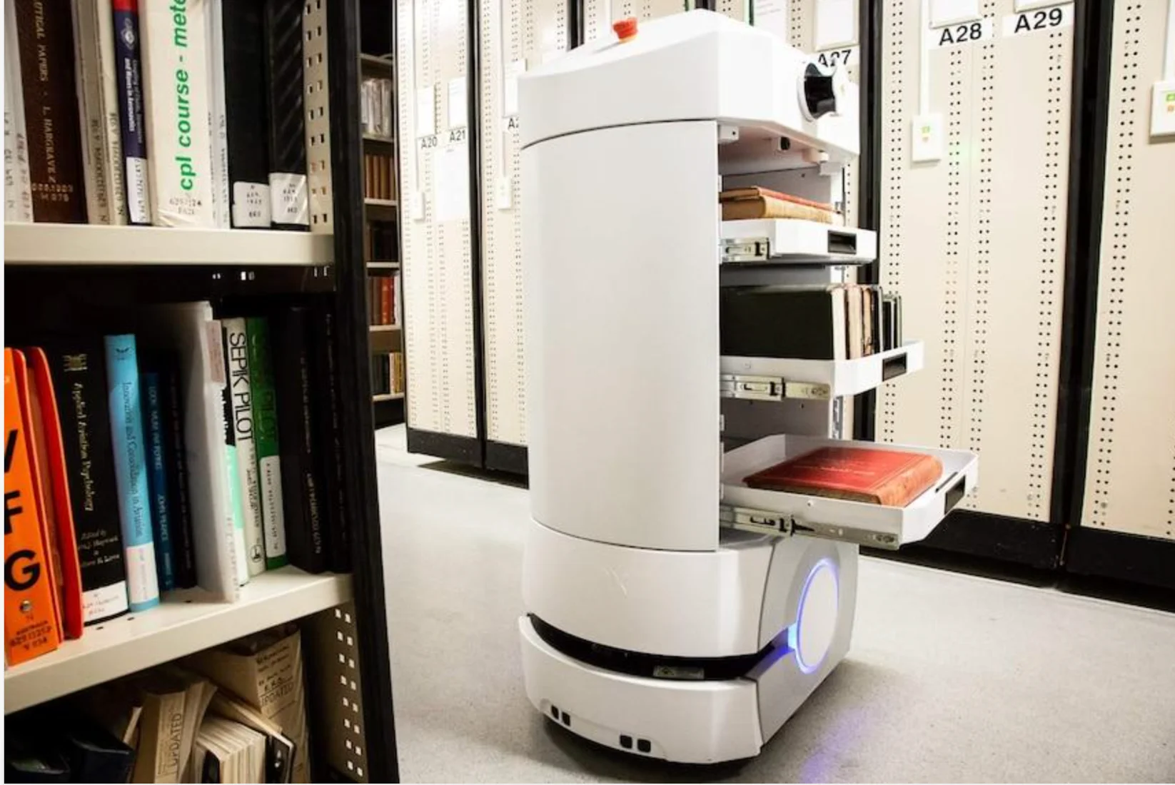 Autonomous book transport robot among library shelving